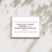 Load image into Gallery viewer, Framed art print of a a quote in cross-stitch black text that reads, “I can do all things through spite which strengthened me.” A cross stitched pink heart border surrounds it.
